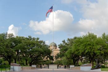 American flag flying in front of the Academic Building