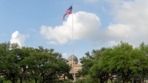 American flag flying in front of the Academic Building