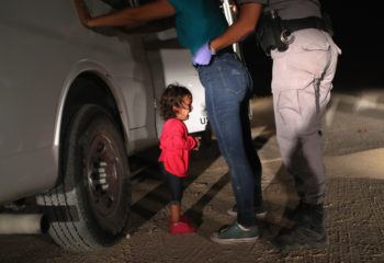 A two-year-old Honduran asylum seeker cries as her mother is searched and detained near the U.S.-Mexico border on June 12, 2018 in McAllen, Texas.
