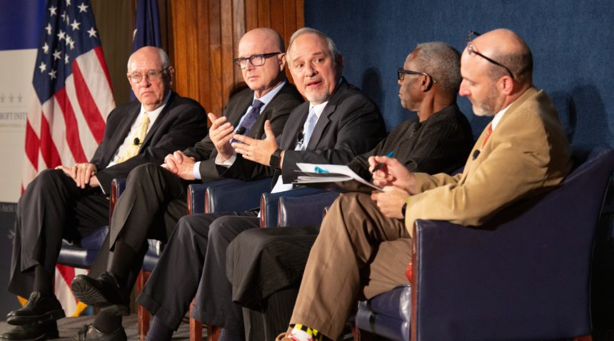 Panelists (right to left) are Dr. David Brett-Major, Professor Oyewale Tomori, Rick Santos, Steve Davis, and Ambassador William Garvelink.