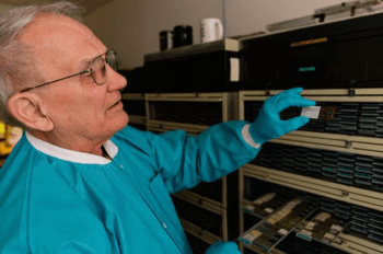 Anthropology Professor Vaughn Bryant analyzes one of his 20,000 pollen samples in his lab. In 45 years at Texas A&M, he has helped solve murders and track terrorists and drug traffickers.