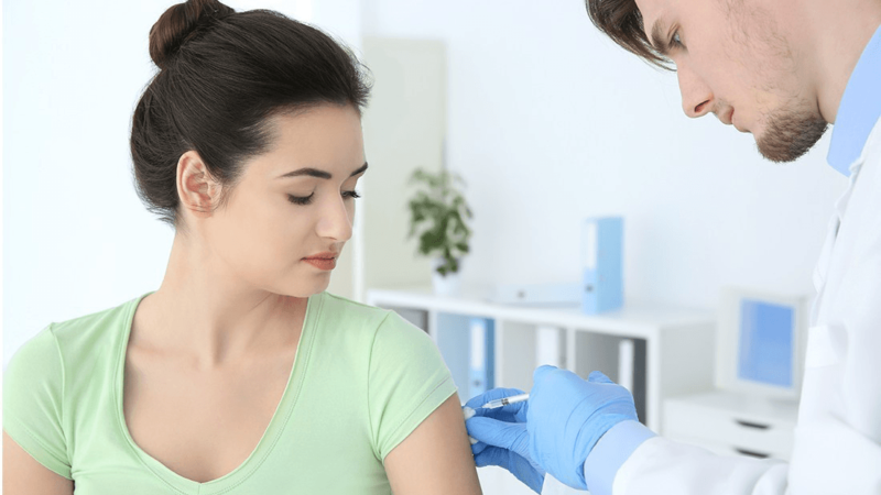 Female patient receives flu shot