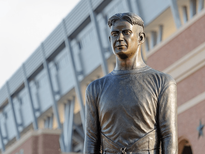 The larger-than-life statue of E. King Gill stands at 12 feet tall on the east plaza of Kyle Field.