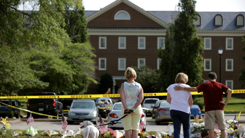 People stop to pay their respects to those killed in a mass shooting at a makeshift memorial outside the City of Virginia Beach Operations Building June 02, 2019 in Virginia Beach, Virginia. Eleven city employees and one private contractor were shot to death Friday in the operations building by engineer DeWayne Craddock who had worked for the city for 15 years. (Photo by Chip Somodevilla/Getty Images)