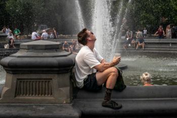  People cool off near the fountain at Washington Square Park