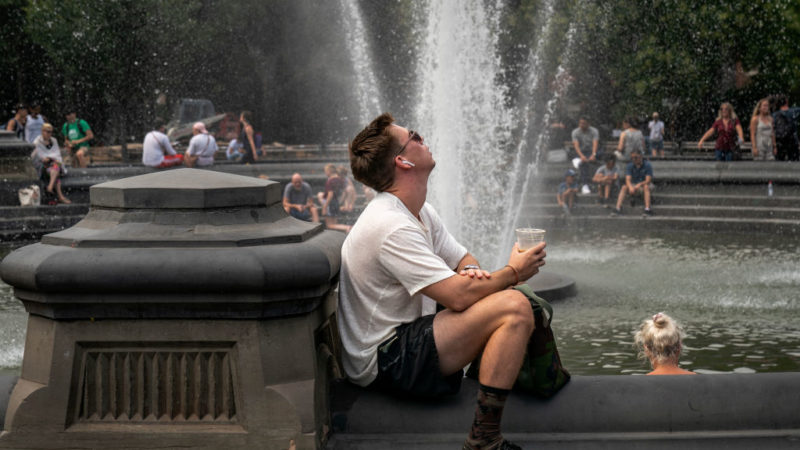 People cool off near the fountain at Washington Square Park