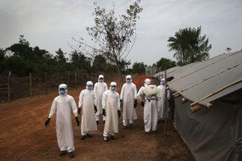 A burial team awaits decontamination at the U.S.-built cemetery for "safe burials" on January 27, 2015 in Disco Hill, Liberia.