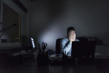 Exhausted businessman at computer
