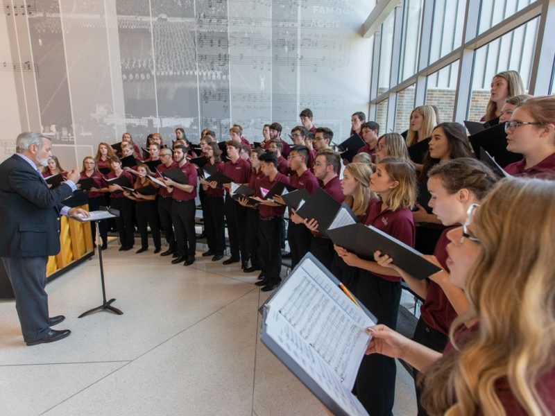 Choral students sing in in the lobby of the Music Activities Center