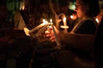 Lighting candles at night during the the 2018 Suicide Awareness Walk.