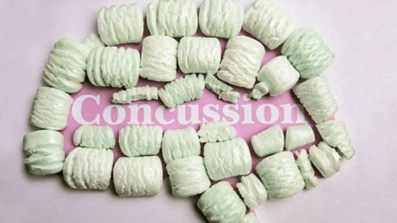 packing peanuts form the shape of a brain around the word concusssion