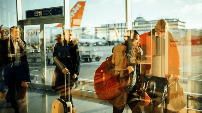 hazy images of people walking past an airport window