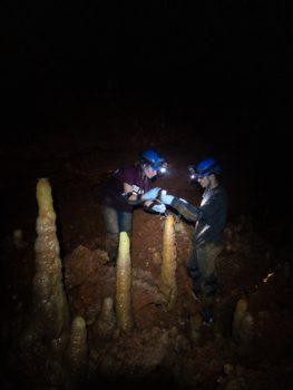 undergraduate students, collecting and monitoring samples and data in a cave.