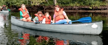 Counselors and campers take a canoe trip during camp.