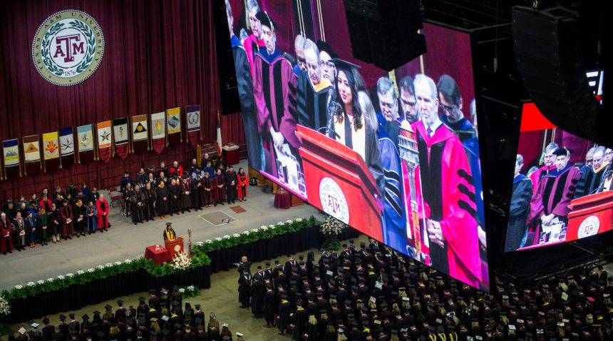 the jumbotron in reed arena showing a graduation speech above the graduates