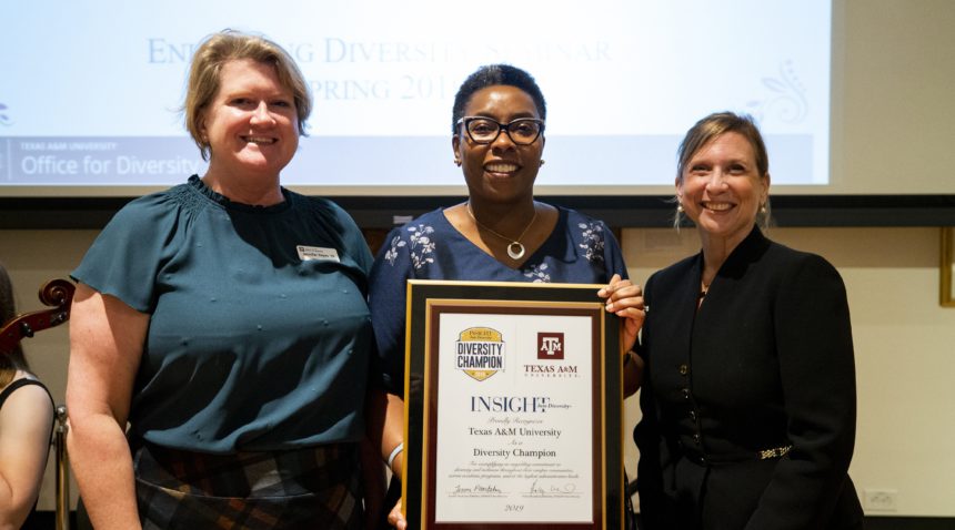 Jennifer Reyes, Robin Means-Coleman and Holly Mendelson pose with the framed Diversity Champion Award