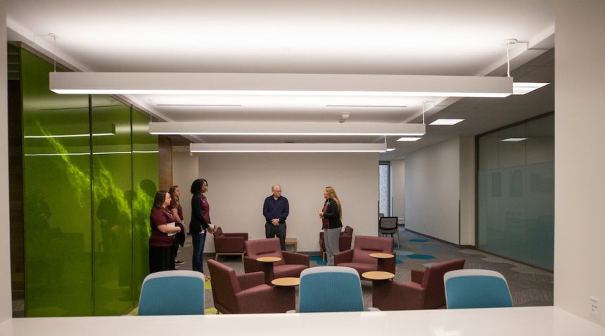 a group of people touring a room in the new building