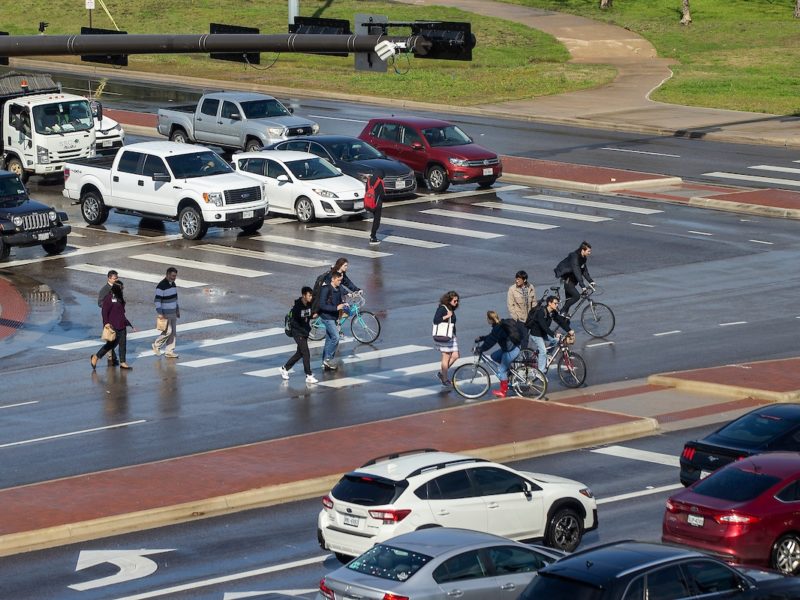 image of people walking through a crosswalk