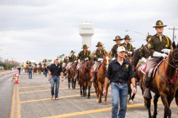 cadets on horses riding in a parade
