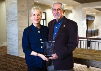 A photo of CVM Dean Eleanor Green and Dr. Henry "Sonny" Presnal posing with Presnal's award