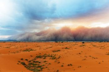 sandstorm moving across a desert