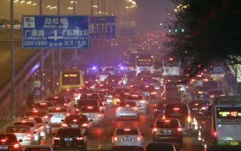 a road crowded with cars in heavy smog