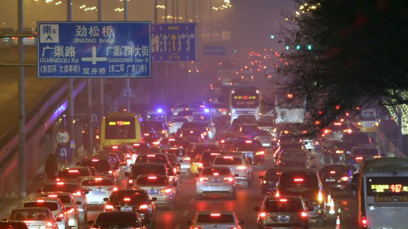 a road crowded with cars in heavy smog
