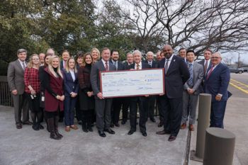 members of North Dallas Bank & Trust pose with Mays Business School officials holding an oversized check for $1 million