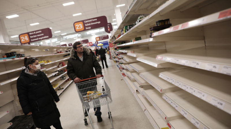 shoppers looking at empty shelves in super market