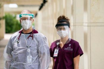 physician and student standing next to each other wearing personal protective equipment