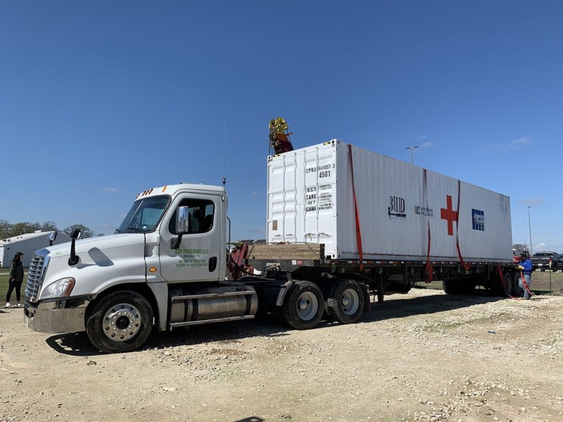 a photo of a BUILD medical clinic on the bed of a truck being prepped to take to Houston