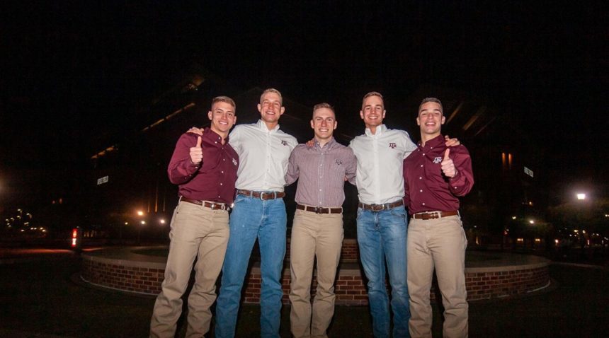 The 2020-21 Yell Leaders posing together on Election Night in front of Kyle Field