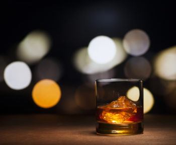 photo of a glass of whisky with ice.