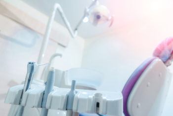 Horizontal color image of dentist's office, dentist tools, equipment and dentist's chair.