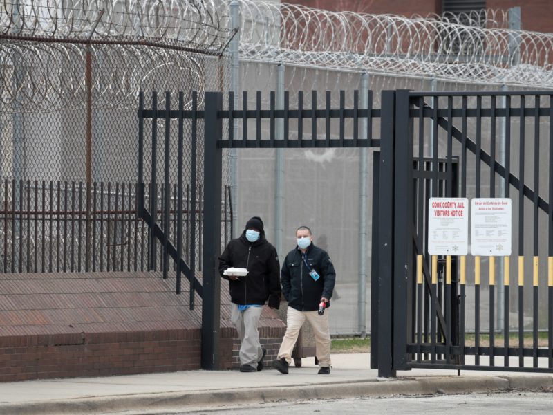 People wearing masks walking out of prison