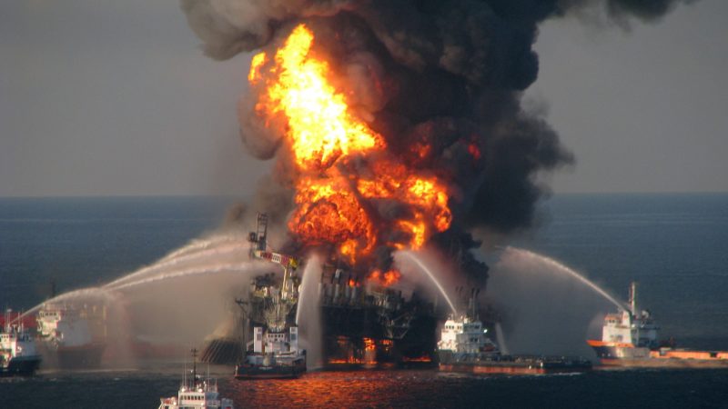 fire boats fight fire caused by an explosion on a flaming off shore oil rig