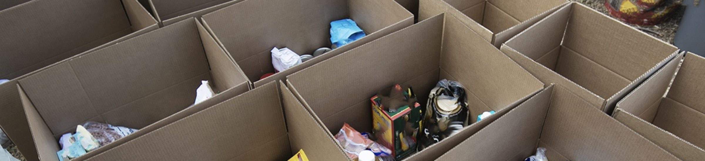a photo of cardboard boxes filled with food donations