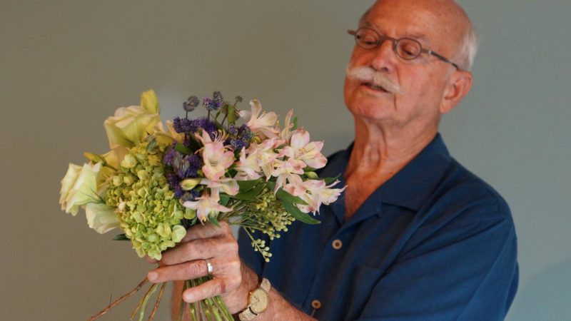 Jim JOhnson holding floral bouqet