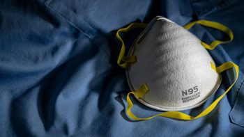 N95 mask sitting on blue fabric