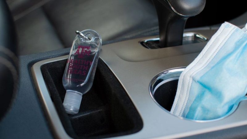 hand sanitizer in car cupholder