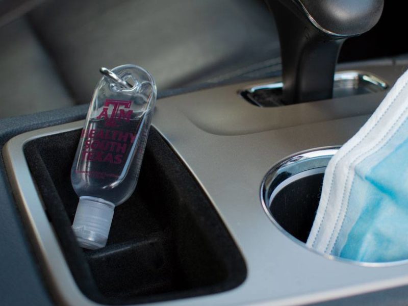 hand sanitizer in car cupholder