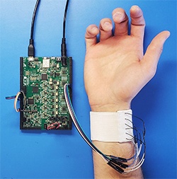 an arm lying palm side up with a device attached to a cuff around the wrist
