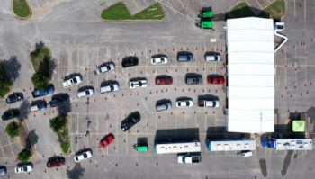 aerial view of cars lined up in parking lot