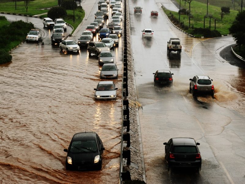 cars stand in traffic submerged in flooded roadway