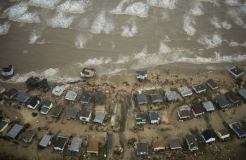 aerial photo of damaged homes on the coast