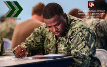 a man in fatigues studying in class