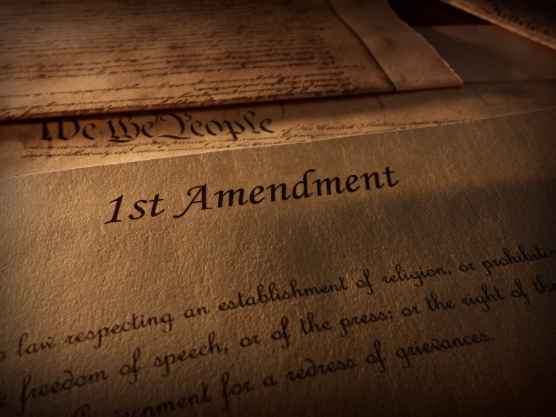 First Amendment of the US Constitution text, with other Constitution text above