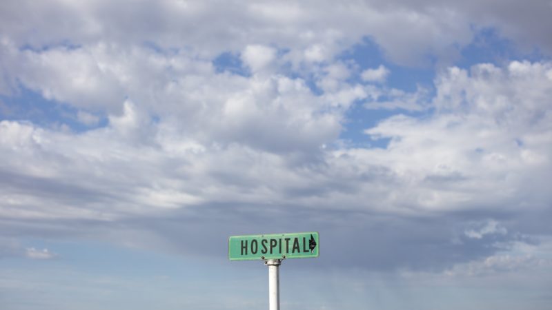 hospital sign with field in background