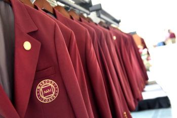 a photo of Foundation maroon coats hanging on a coat rack
