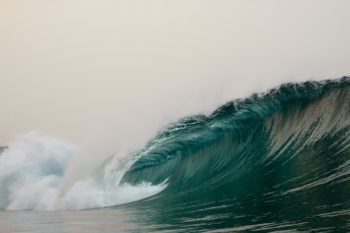 A wave breaks on a beach